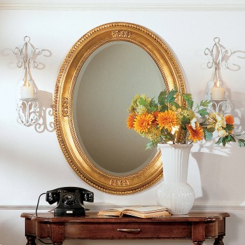 Specchiera ovale cornice foglia oro su parete decorativa
