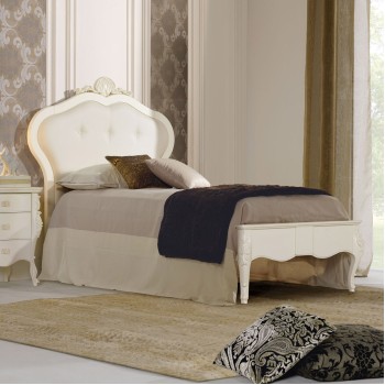 Letto singolo in legno con testata imbottita, intagli